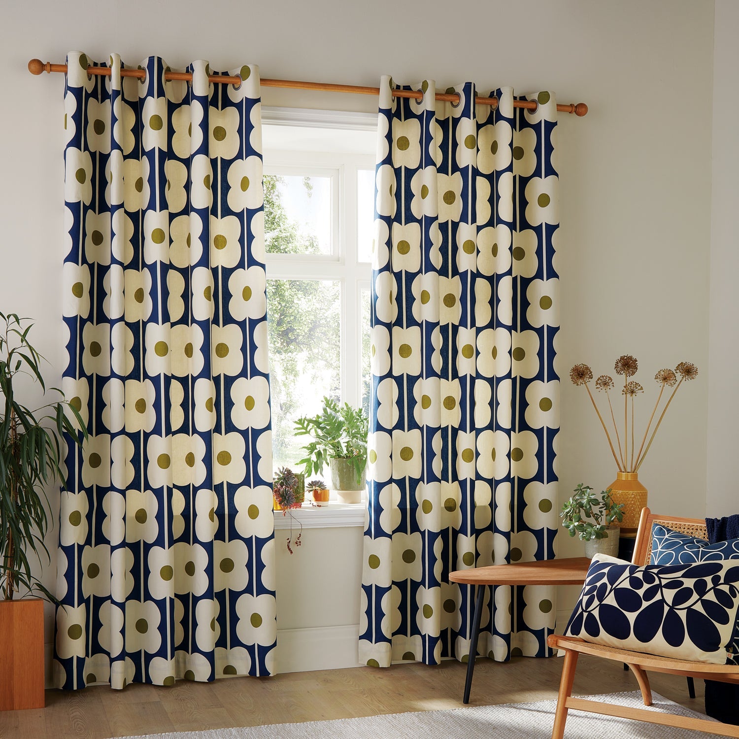 A pair of flower eyelet curtains in navy blue.