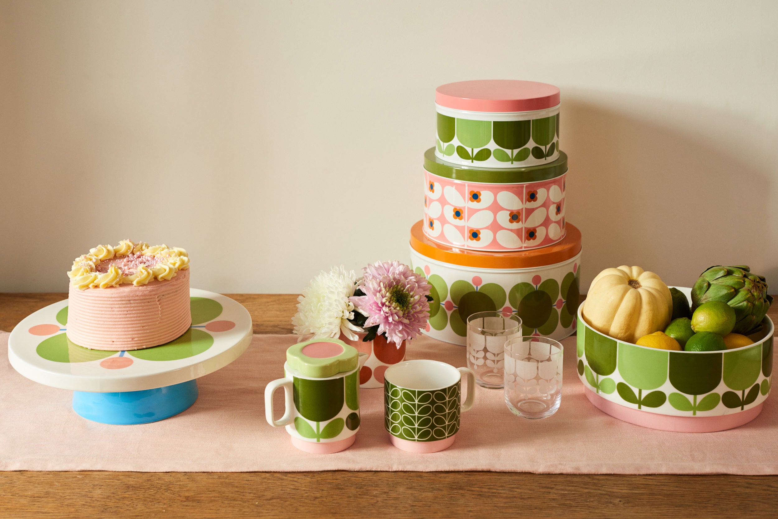A cake stand, cake tins, mugs and fruit bowl by Orla Kiely