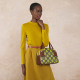 Model wearing the Luna Bowling Bag in Purple Puzzle Flower pattern by Orla Kiely