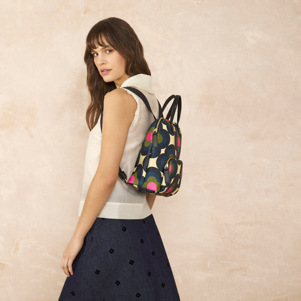 Model wearing the Buddy Backpack in Radial Flower Rockpool pattern by Orla Kiely
