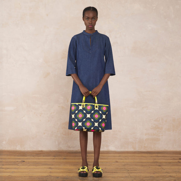 Model wearing the Smile Tote Bag in Radial Flower Rockpool pattern by Orla Kiely