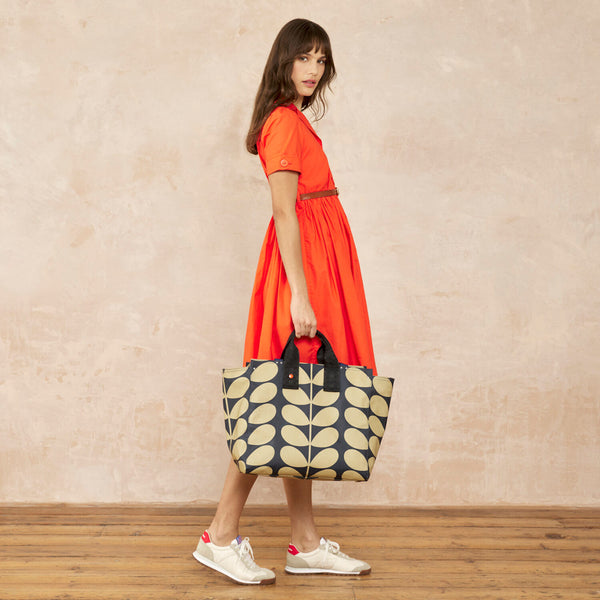 Model wearing the All In Tote Bag in Solid Stem Oatmeal pattern by Orla Kiely