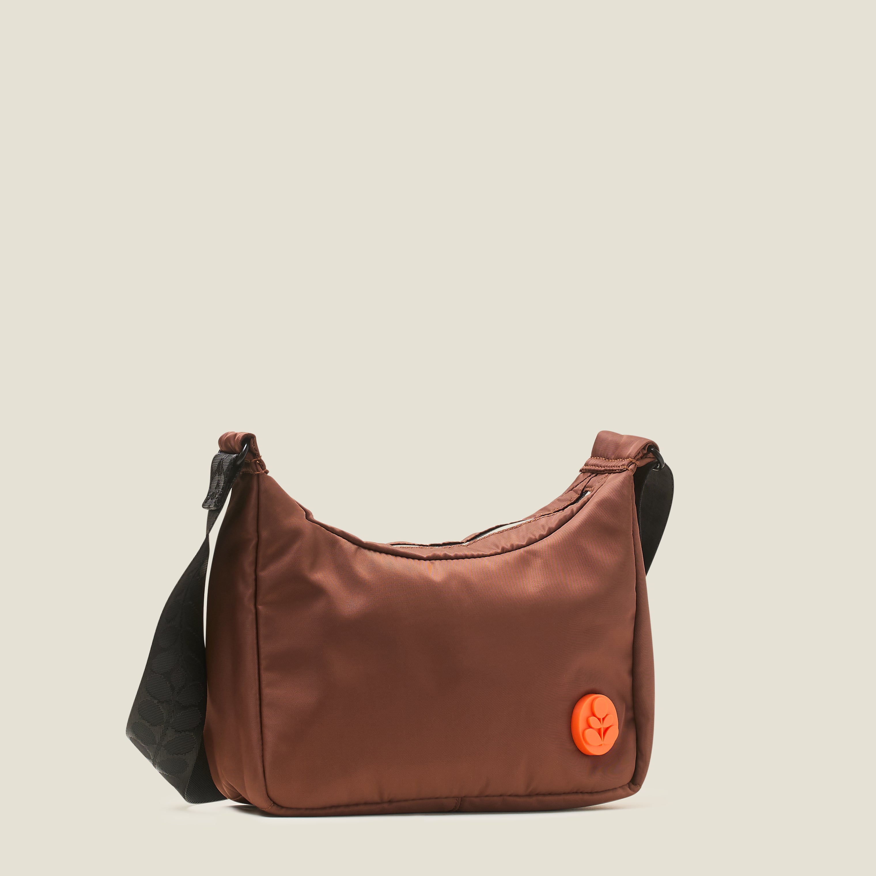 Front view of the Ratio Small bag in brown, a crossbody bag with an orange Orla Kiely logo.