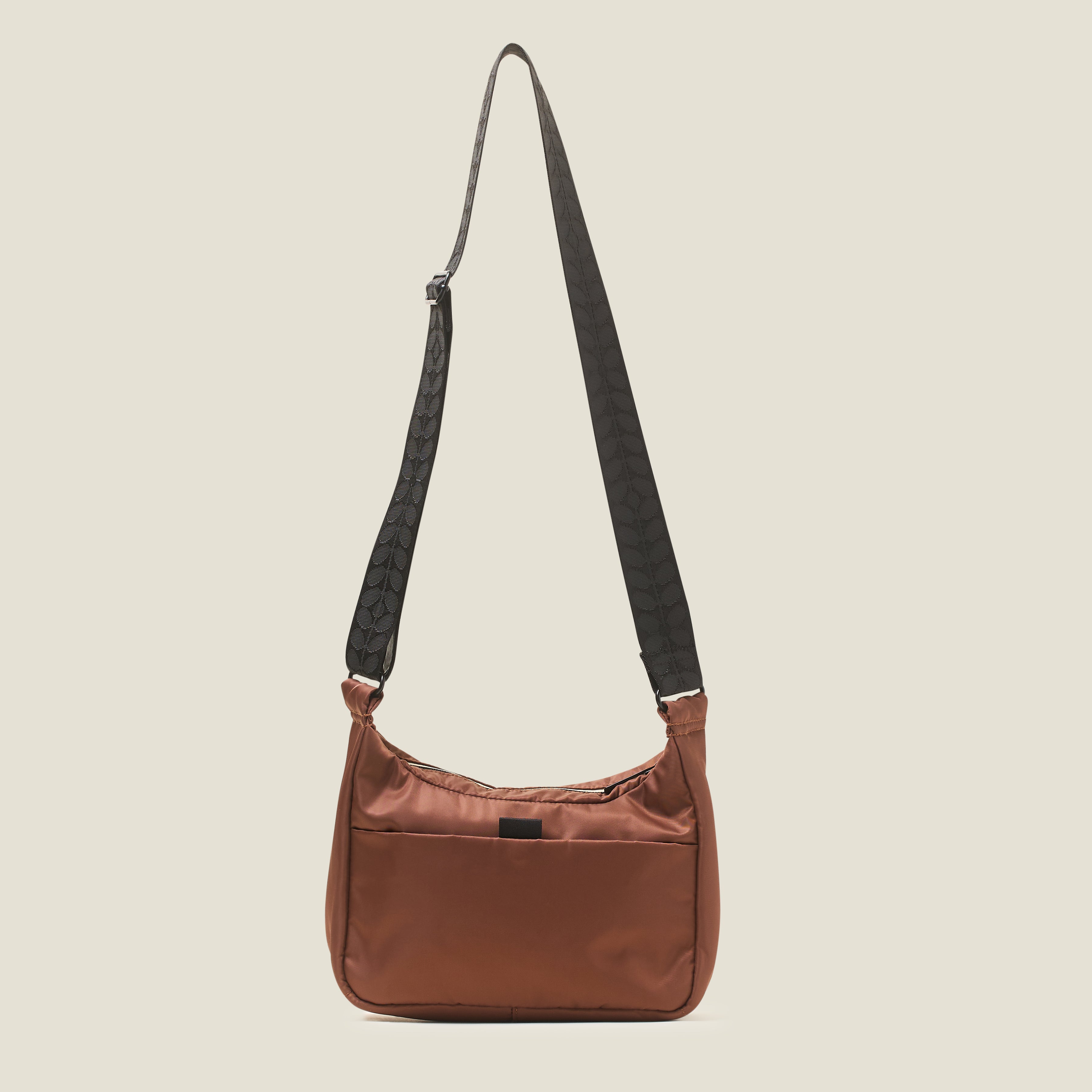 back view of the Ratio Small bag in brown, a crossbody bag with an adjustable strap and a back pocket.
