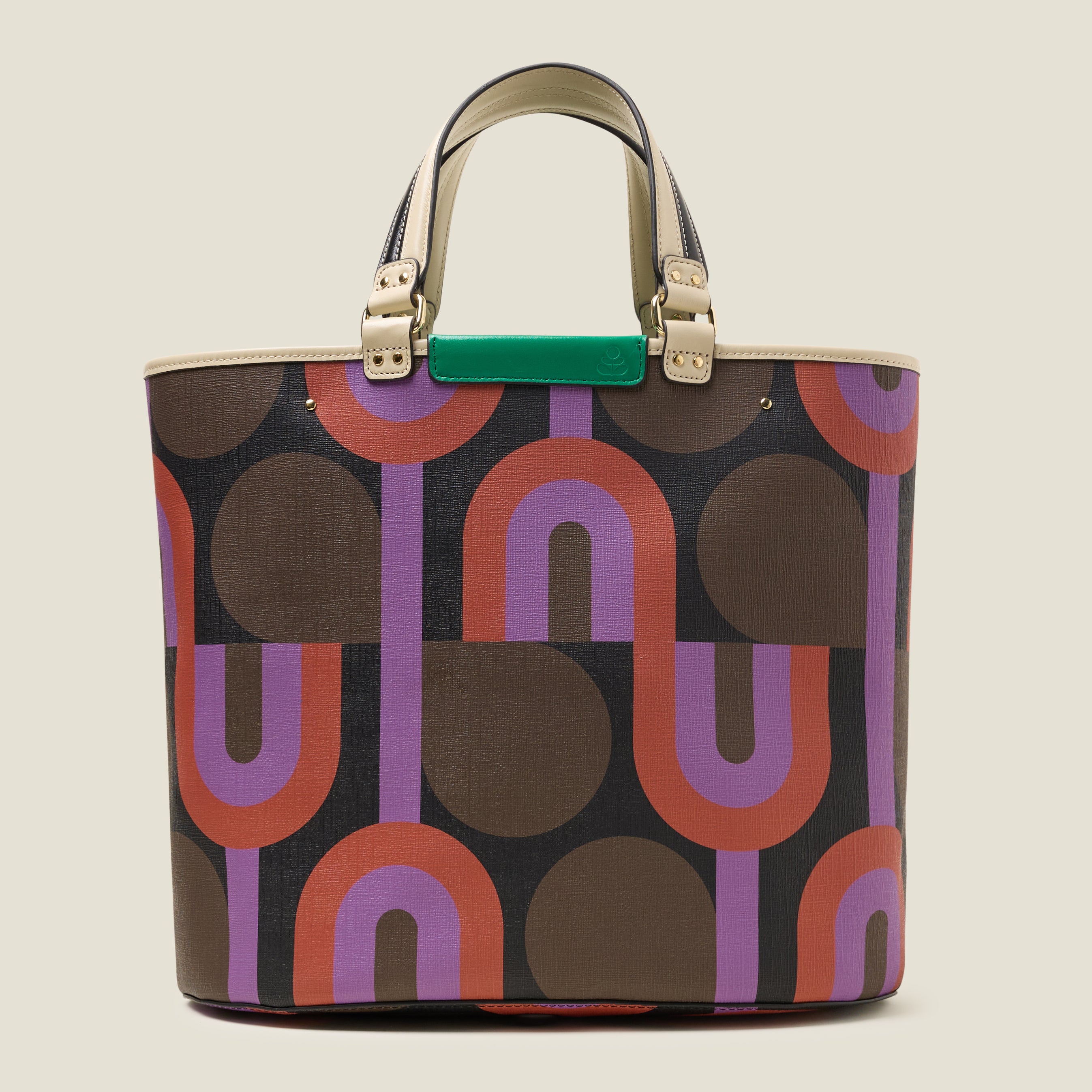 Front view of a large tote bag with purple, red, brown and black retro inspired pattern, featuring leather grab handles and green branding.