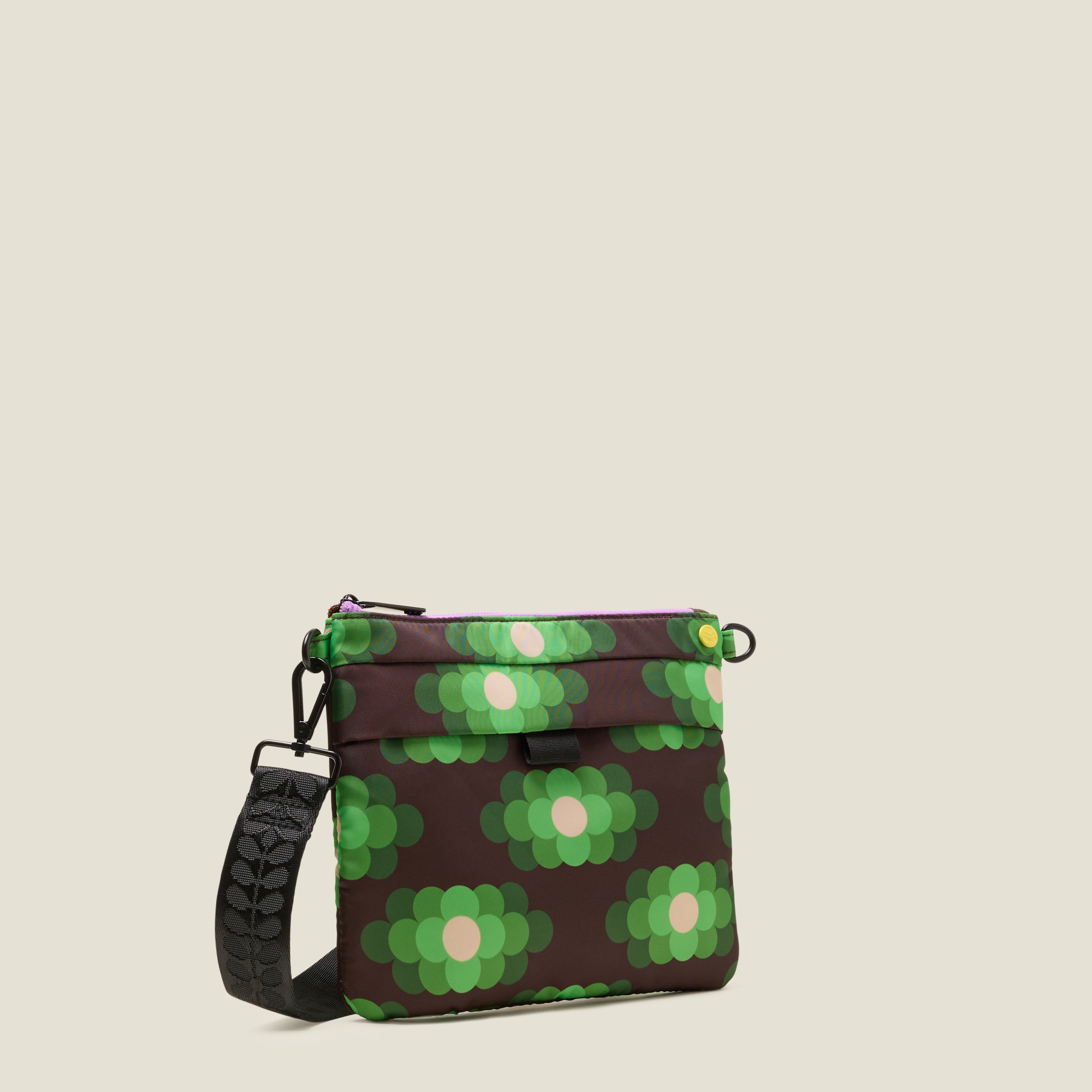 Crossbody bag with green floral pattern on a beige background