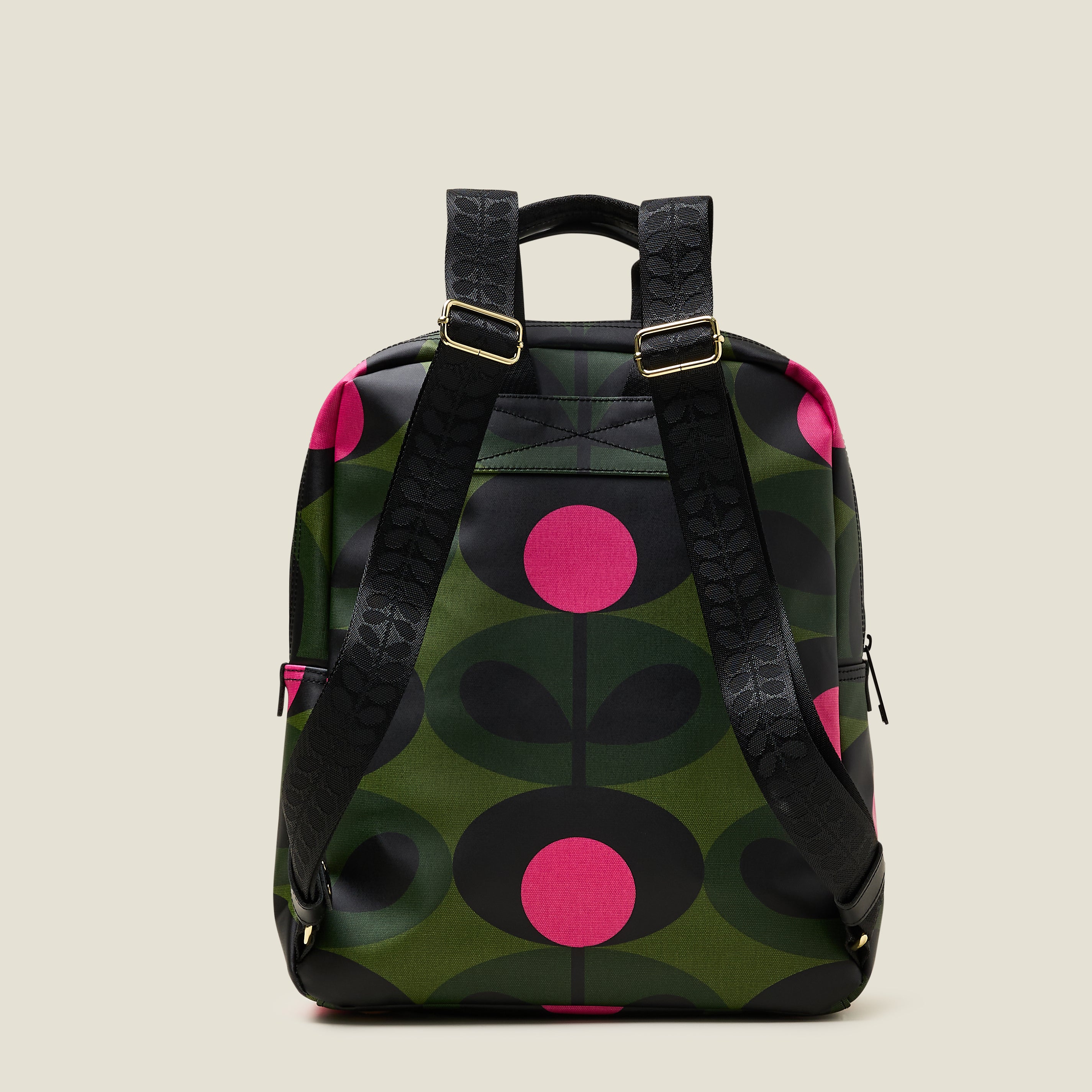 Back view of the Lotta Backpack in a green stem print with bright pink dots, featuring branded grab handles and adjustable shoulder straps.