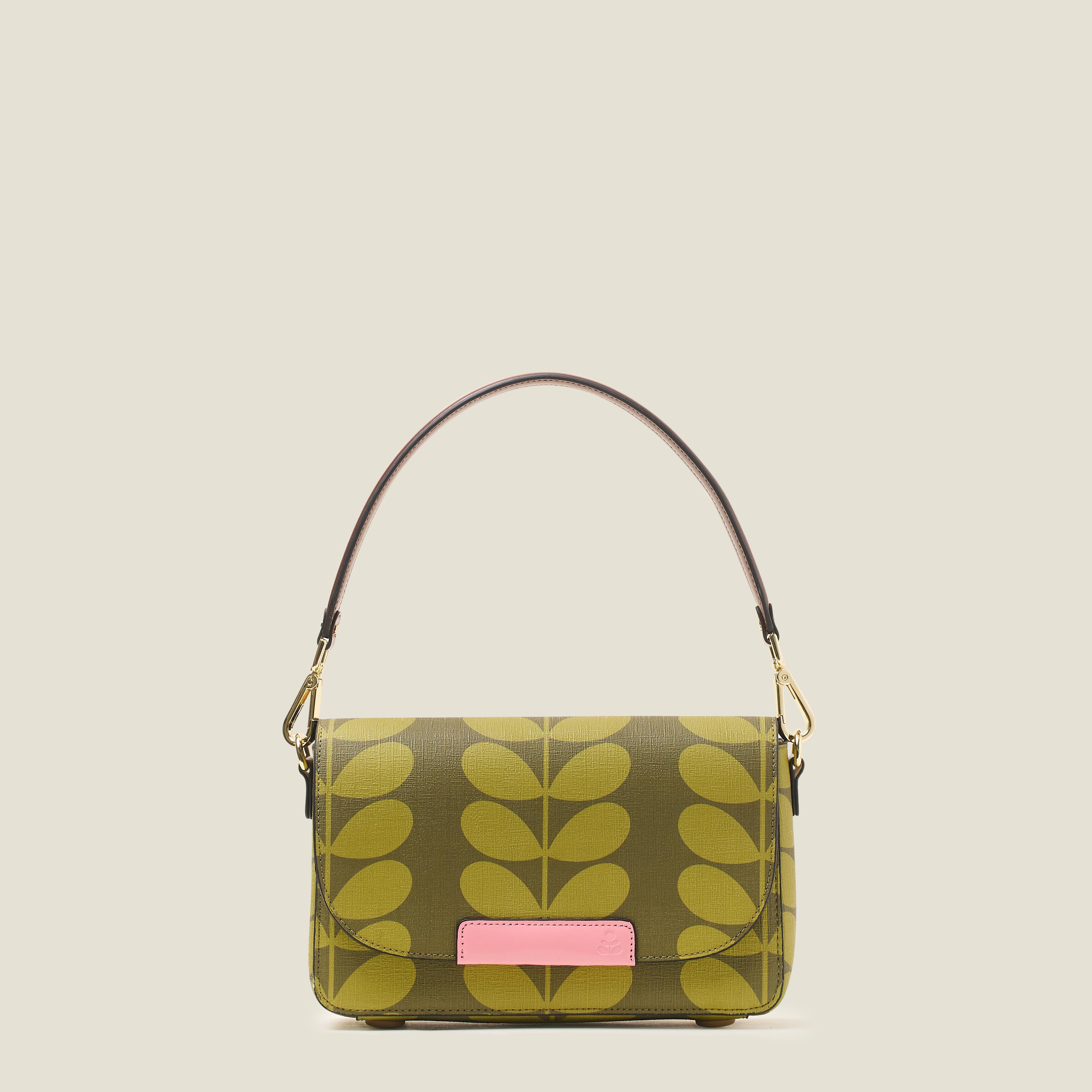 Front view of a women's handbag in a green leaf pattern, featuring leather shoulder strap and pink branding.