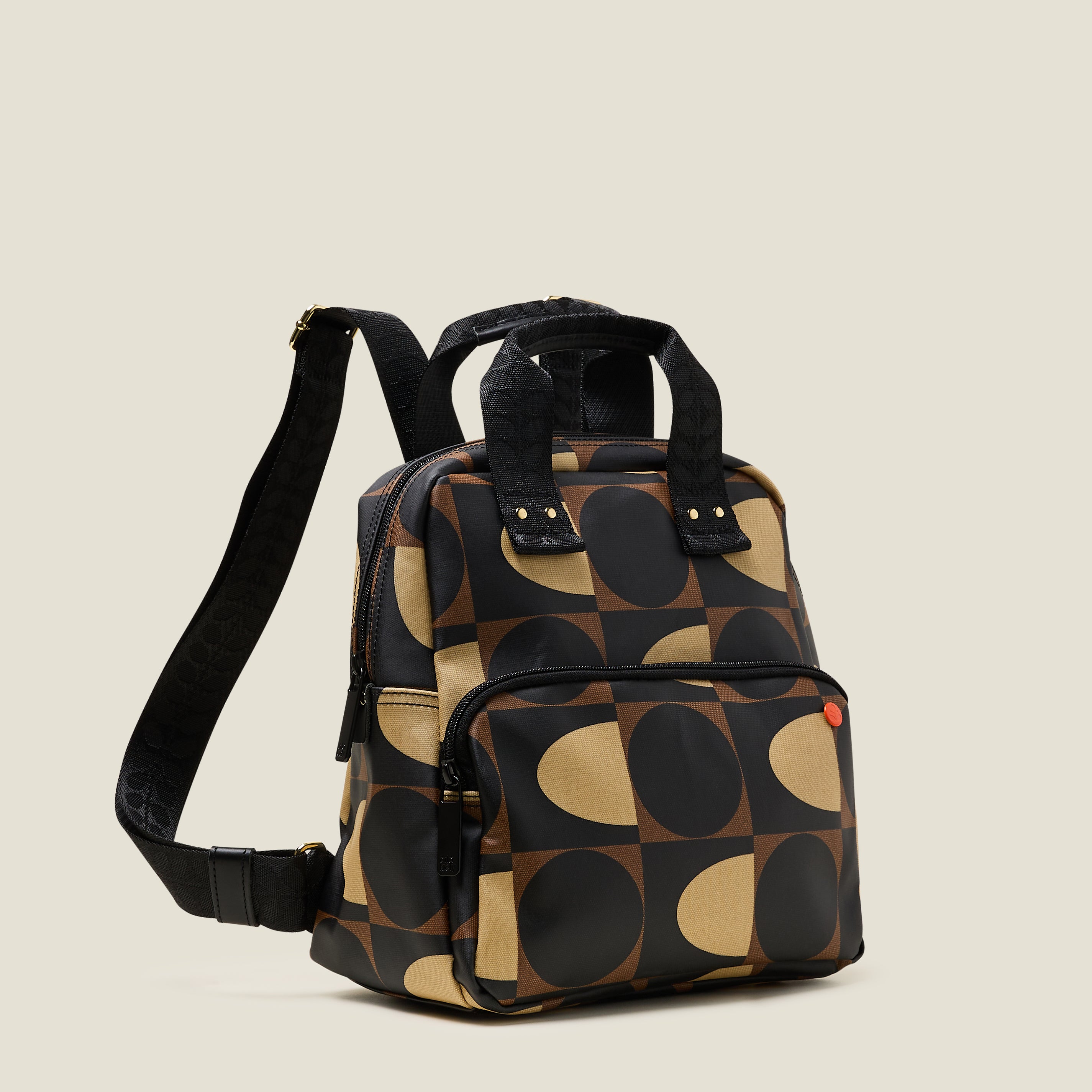 Side view of Mini Lotta Backpack with brown geometric pattern, featuring a front zipper pocket and branded straps.