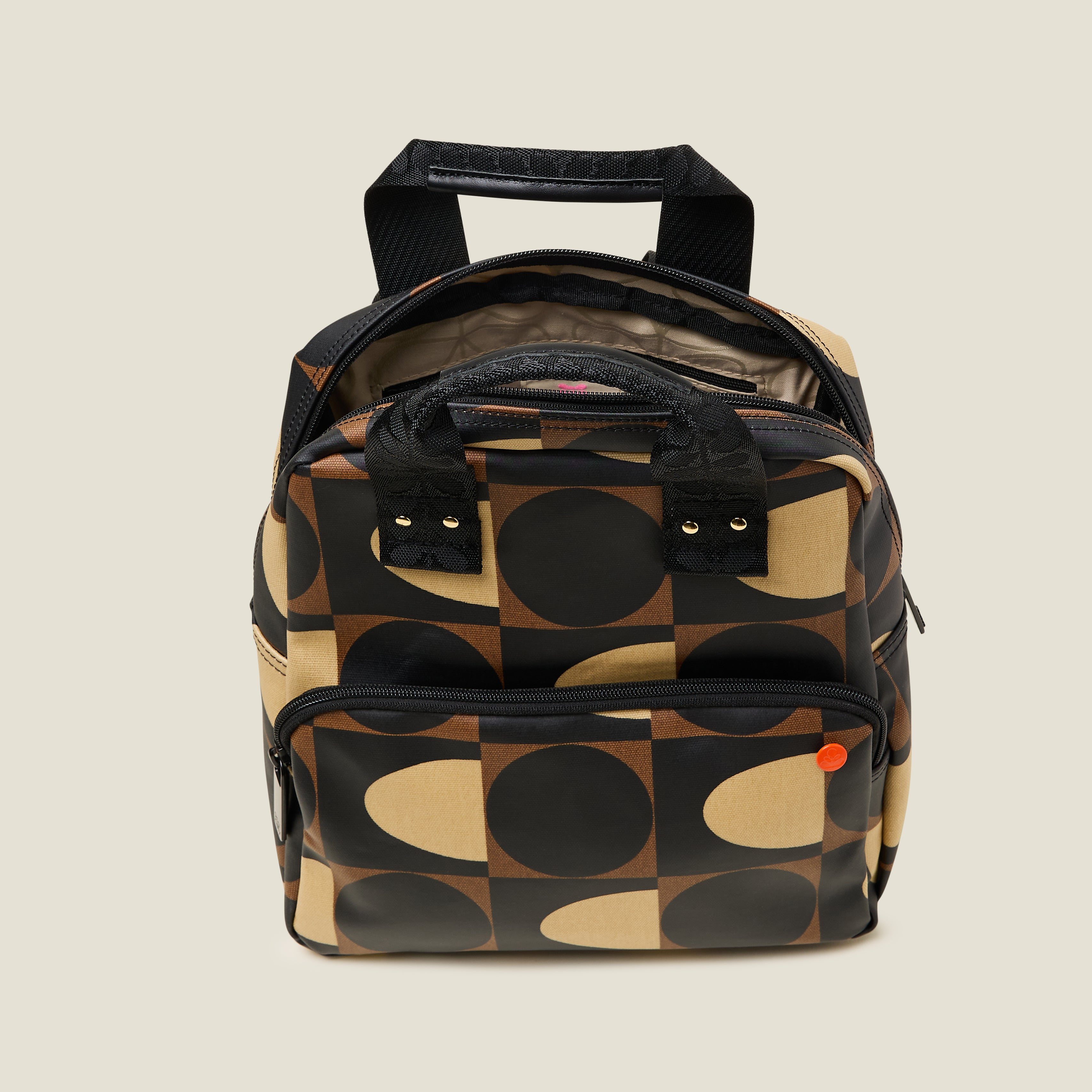 Inside view of Mini Lotta Backpack with brown geometric pattern, featuring an inside zipper pocket and branded lining.
