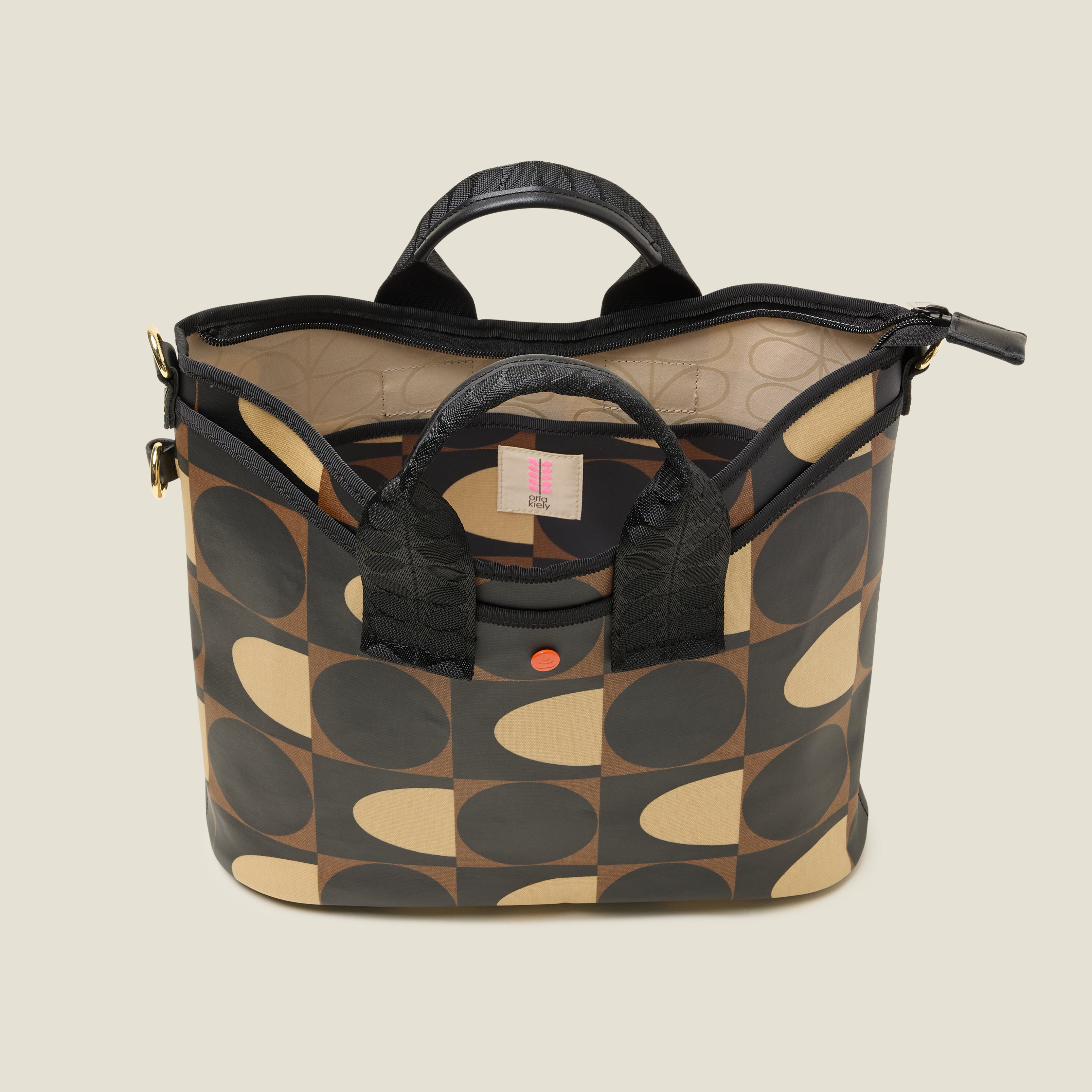Inside view of a patterned handbag, with internal slip pocket in geometric mocha brown print design