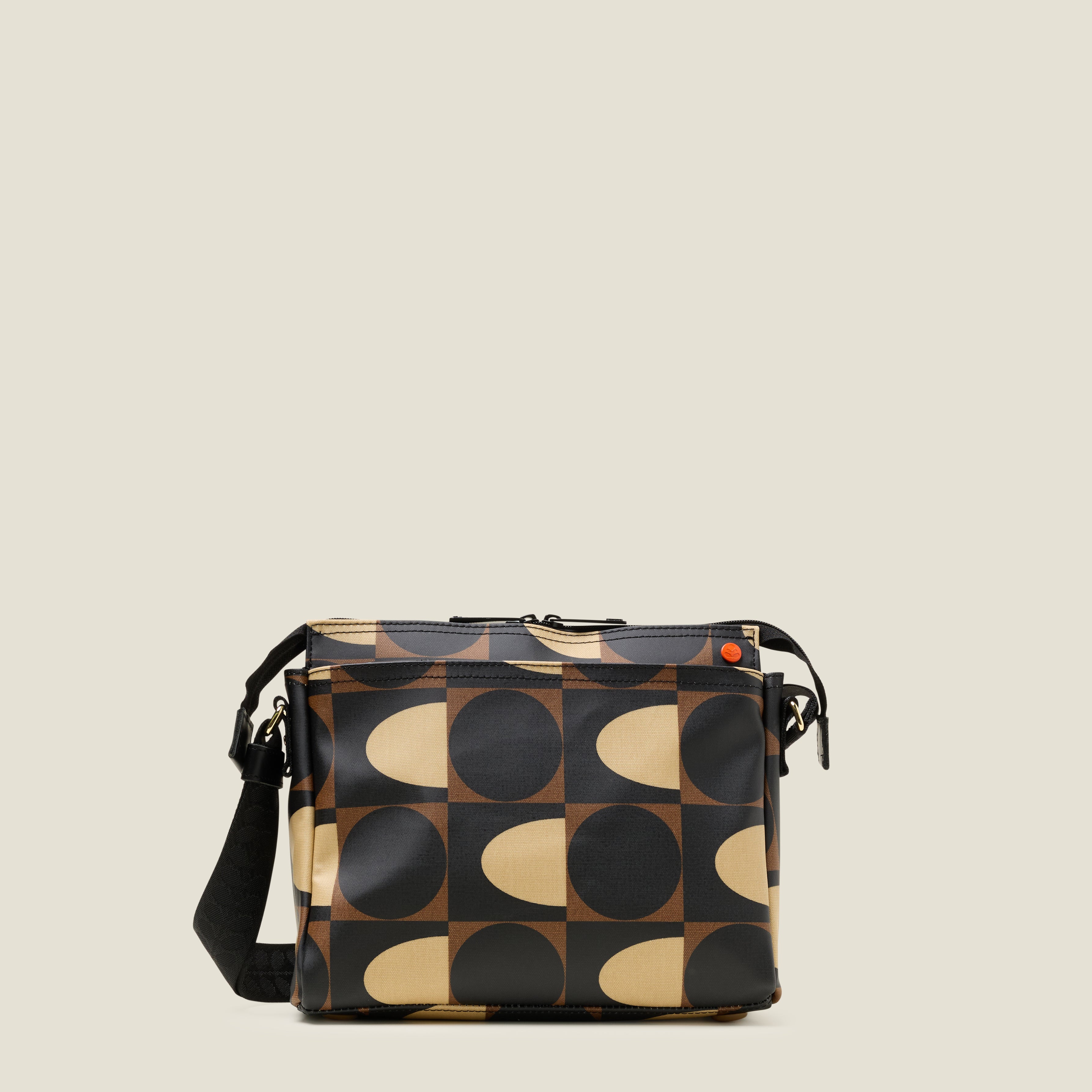 Front view of the Fielder Crossbody bag in a brown and cream retro pattern, with front pocket and zip closure.