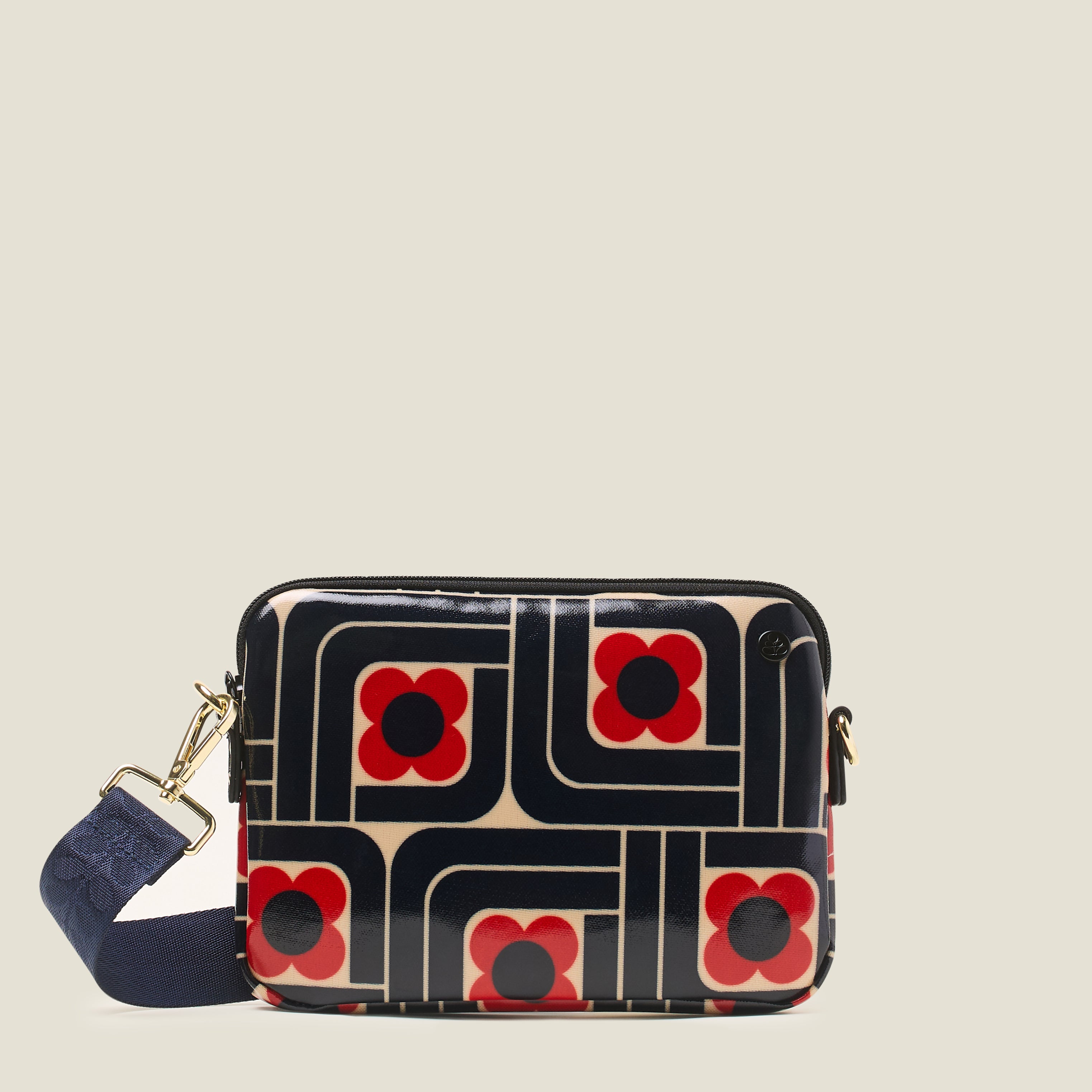 Front view of the slim crossbody patterned handbag in navy, red and cream.