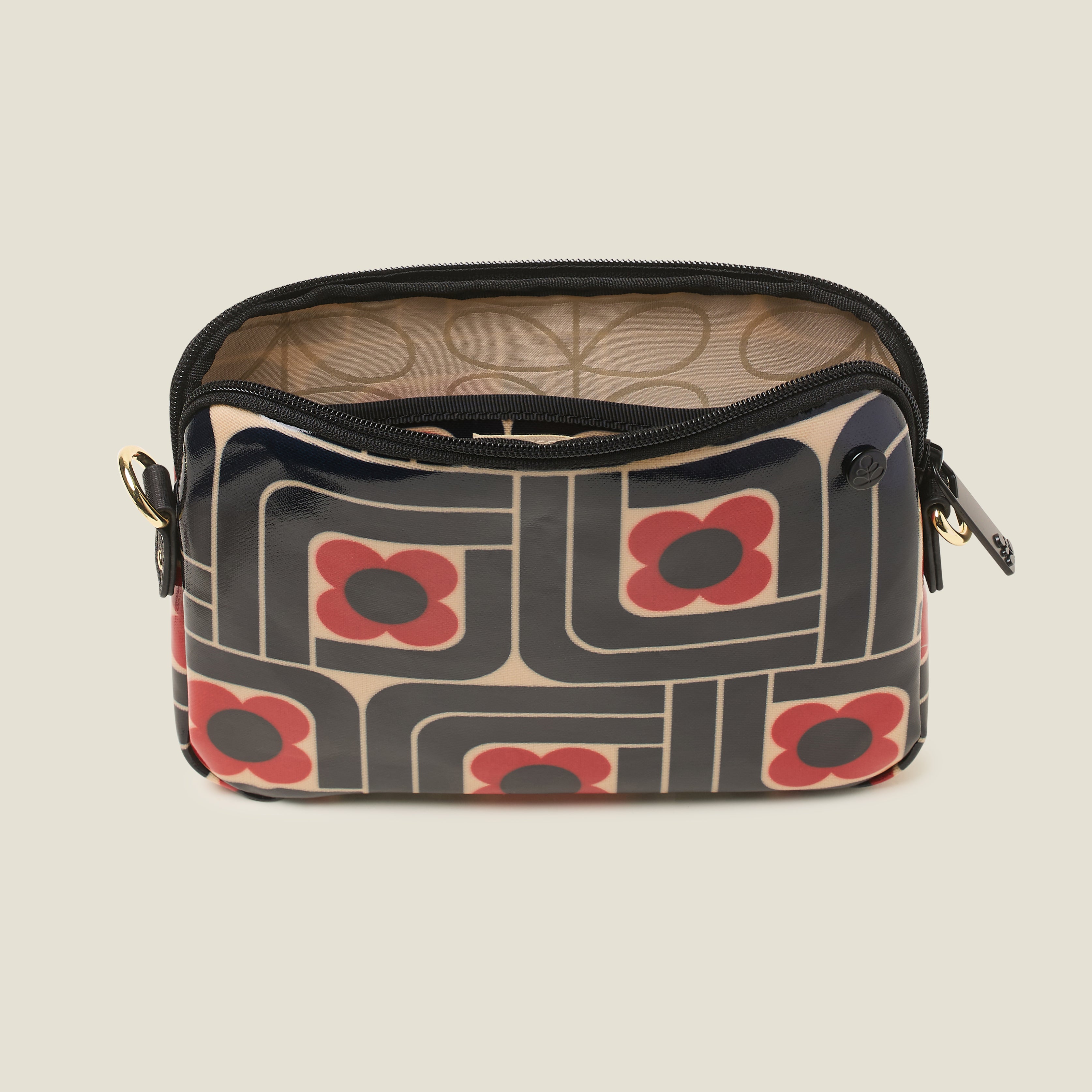 Top view of the slim crossbody patterned handbag in navy, red and cream with patterned lining.