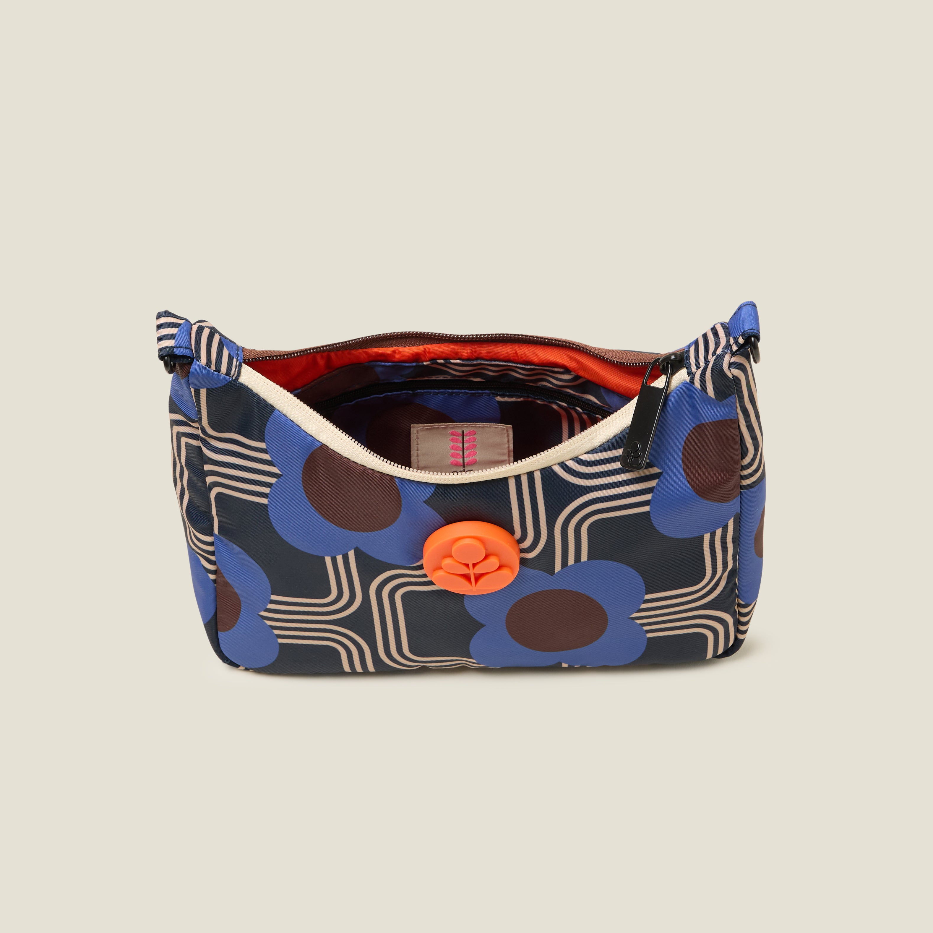 Top view of the Venn handbag with zip closure open to reveal the orange lining , featuring electric cobalt blue floral pattern with Orla Kiely rubber orange stem branding.