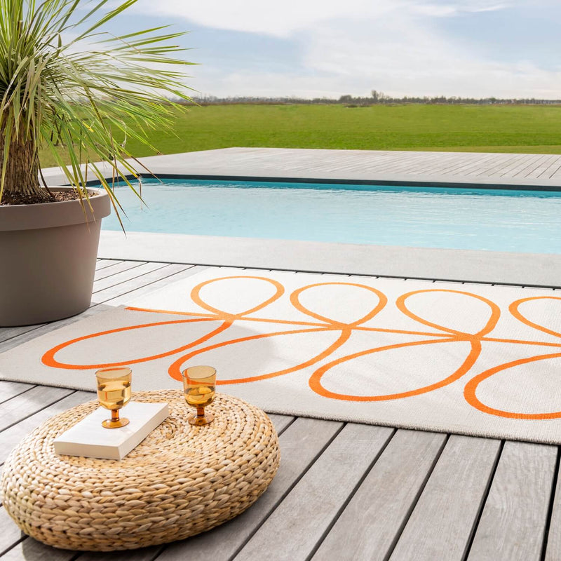 Lifestyle picture of persimmon Orla Kiely stem outdoor rug