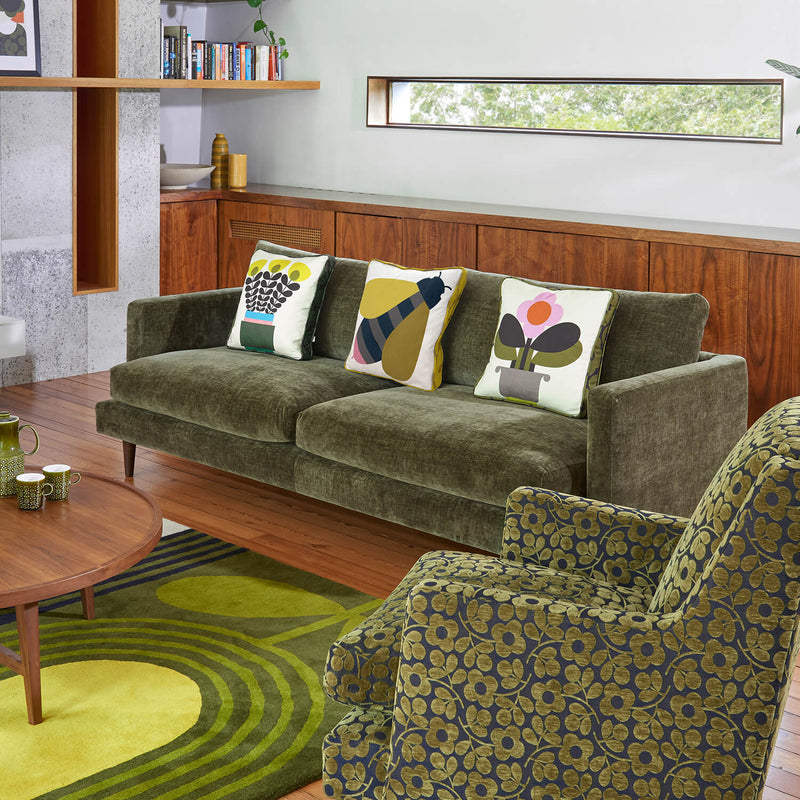 Lifestyle image of the Orla Kiely Larch Sofa in green floral