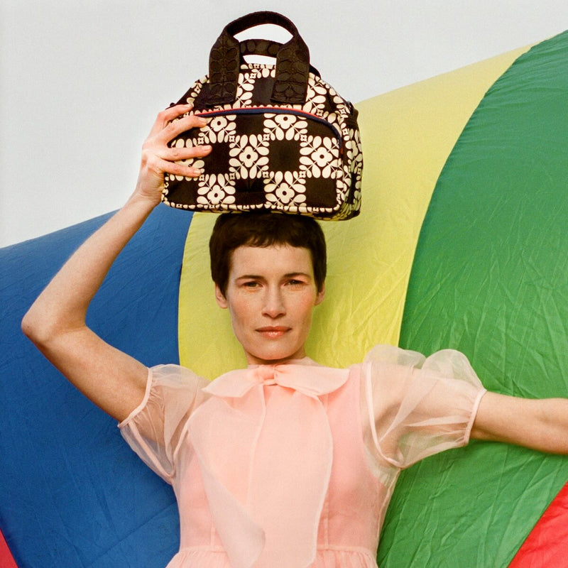 Model with Orla Kiely radial handbag on head
