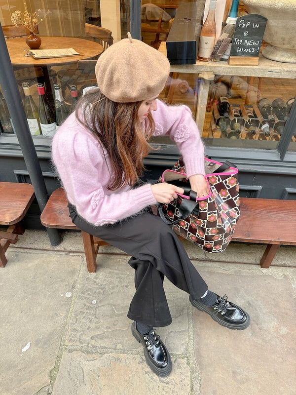 An influencer rummaging through her Orla Kiely carryall tote