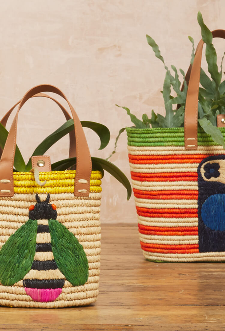 Orla Kiely raffia basket bags being used as plant pots