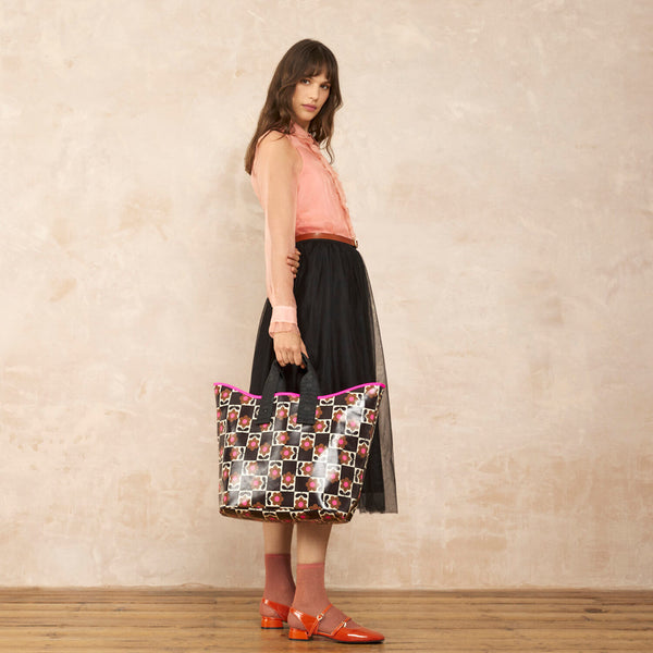 Model wearing the Carryall Large Tote Bag in Flower Pot Chestnut pattern by Orla Kiely