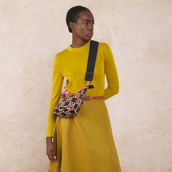 Model wearing the Carrymin Crossbody Bag in Flower Pot Chestnut pattern by Orla Kiely