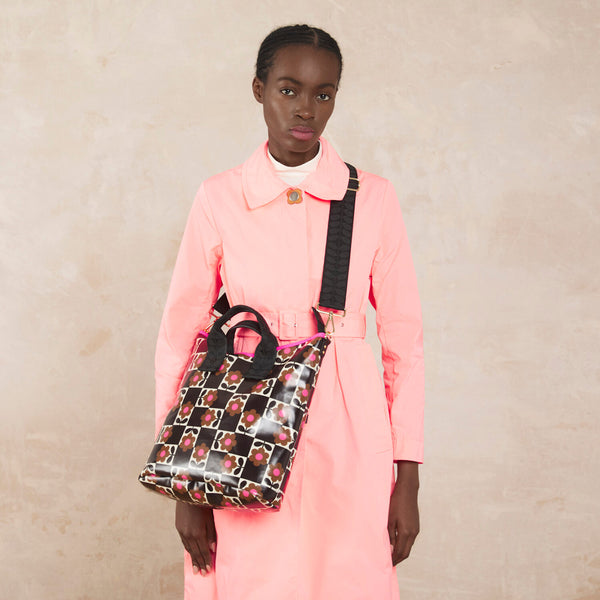 Model wearing the Carry Grab Bucket Bag in Flower Pot Chestnut pattern by Orla Kiely