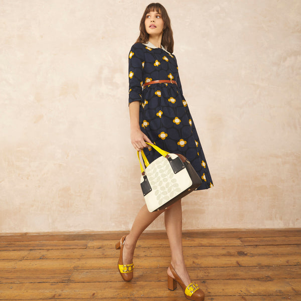 Model wearing the Luna Bowling Bag in Cream Punched Flower pattern by Orla Kiely