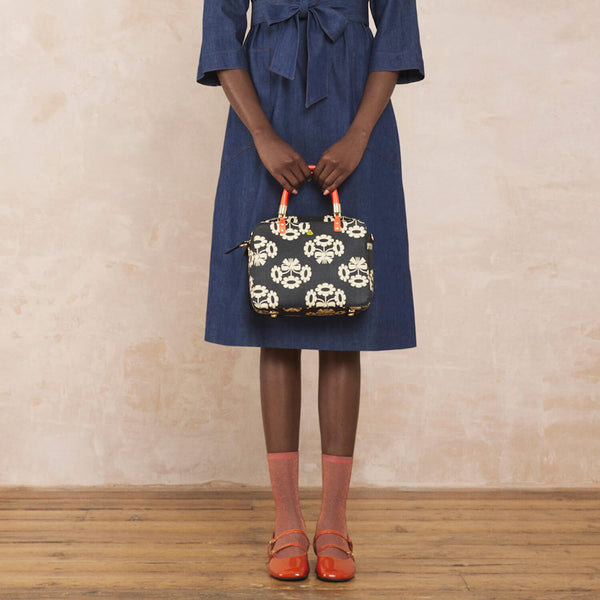 Model wearing the Block Medium Handbag in Posey Flower Midnight pattern by Orla Kiely