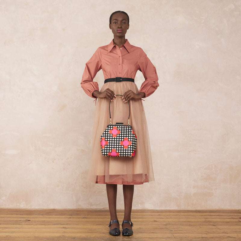 Model wearing the Jenny D Handbag in Fuchsia Flower Polka Dot pattern by Orla Kiely