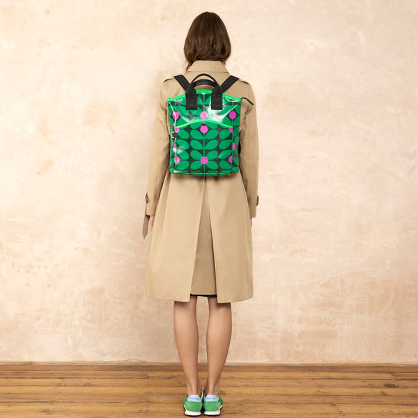 Model wearing the Carry Backpack in Sixties Stem Emerald pattern by Orla Kiely