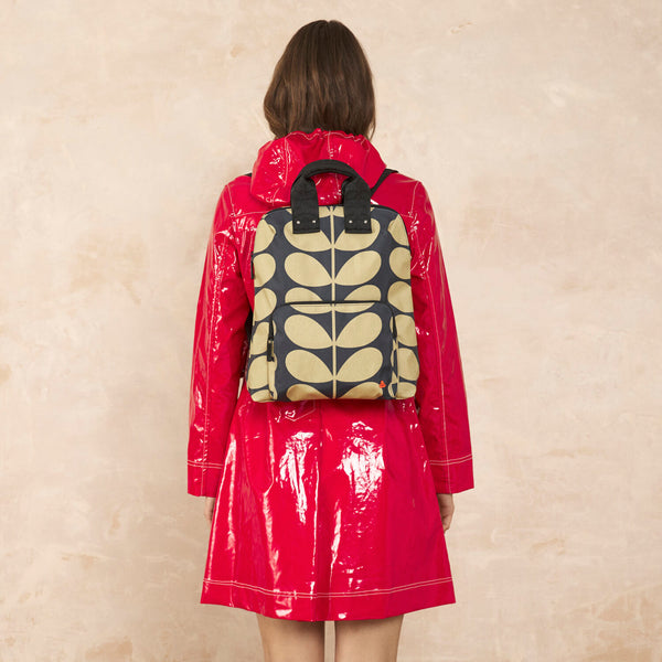 Model wearing the Bestie Backpack in Solid Stem Oatmeal pattern by Orla Kiely
