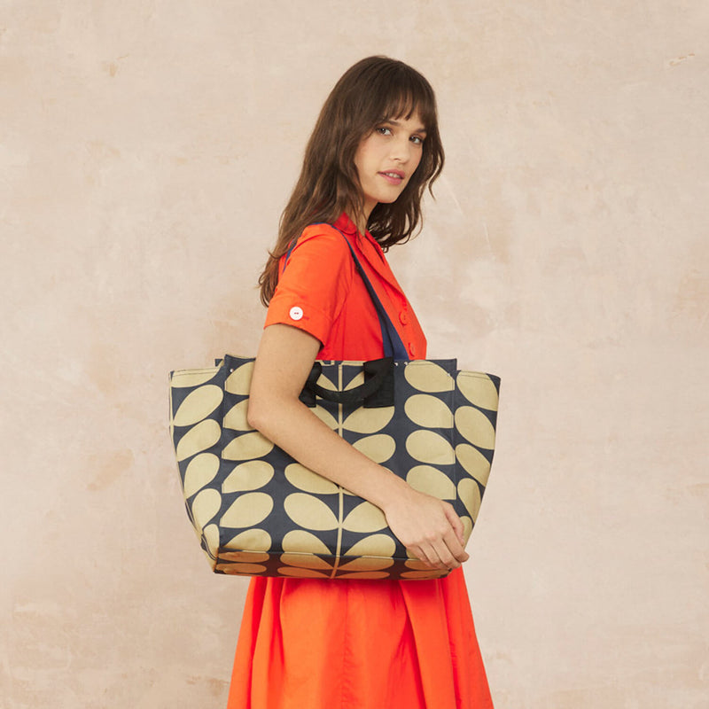 Model wearing the All In Tote Bag in Solid Stem Oatmeal pattern by Orla Kiely