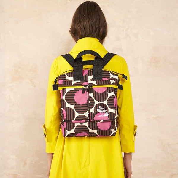 Model wearing the Axis Medium Backpack in Striped Flower Azalea pattern by Orla Kiely
