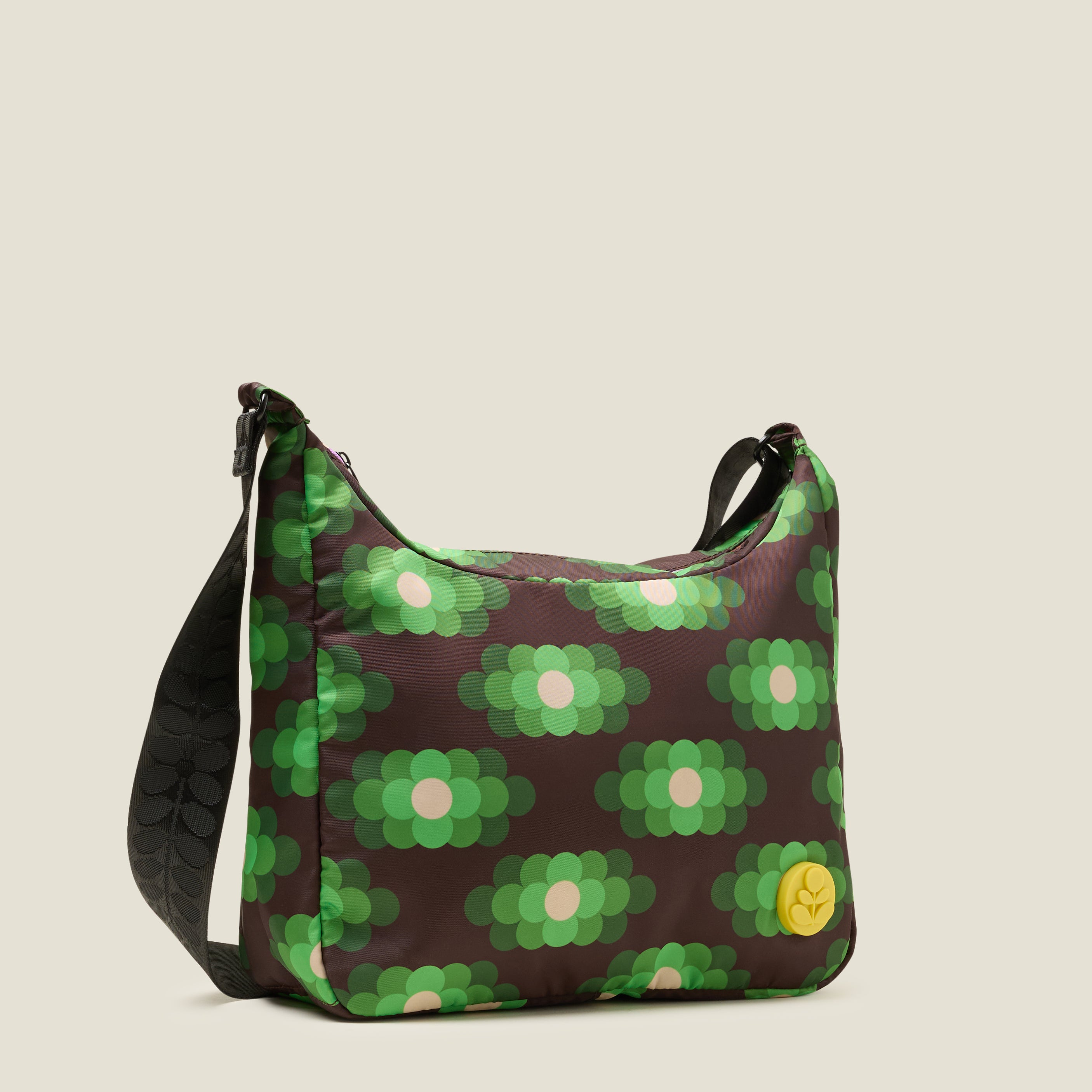 Side view of crossbody bag in a neon green floral pattern. The handbag features a yellow stem logo detail.