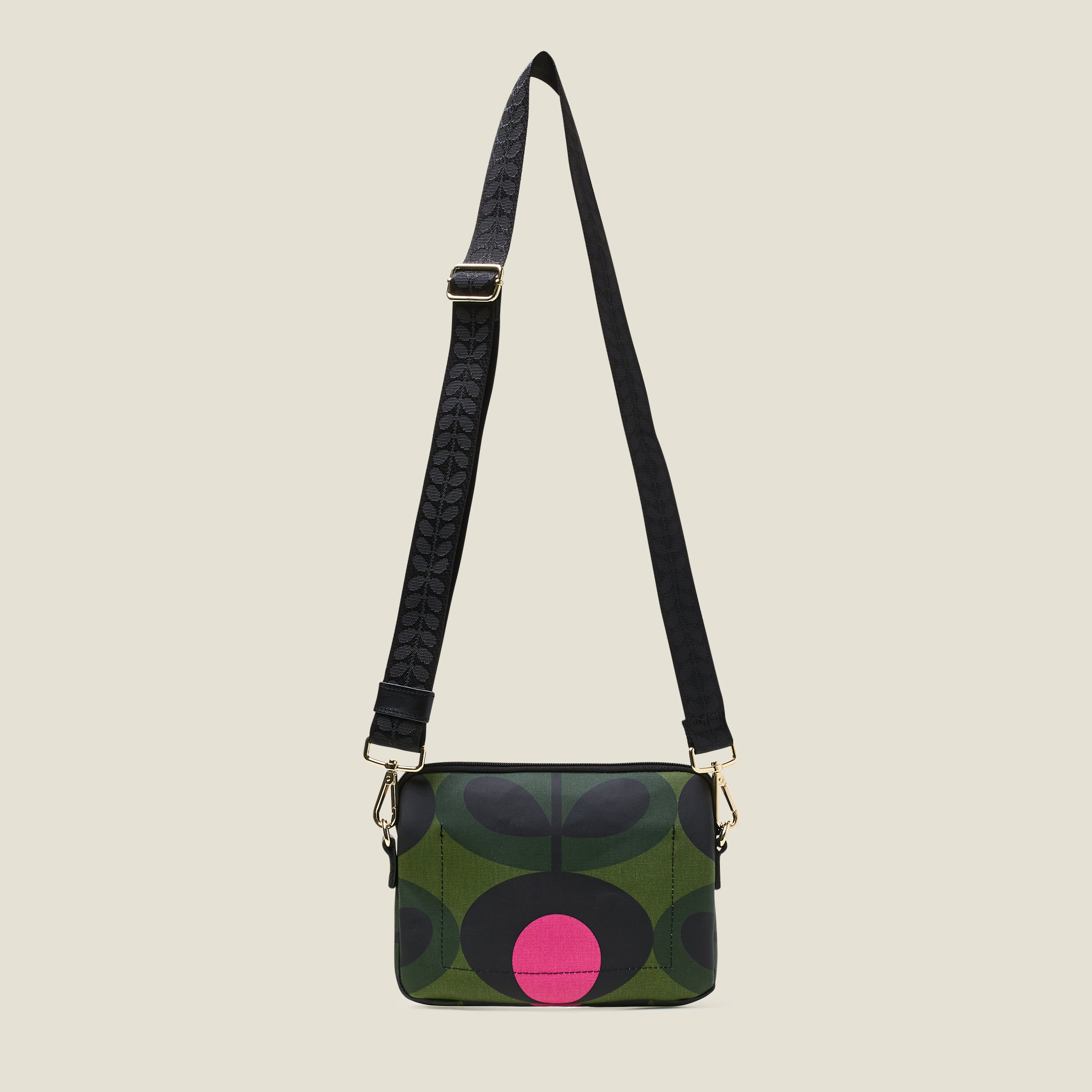 Back view of green patterned slim crossbody bag with a pink flower, zip closure and crossbody strap.