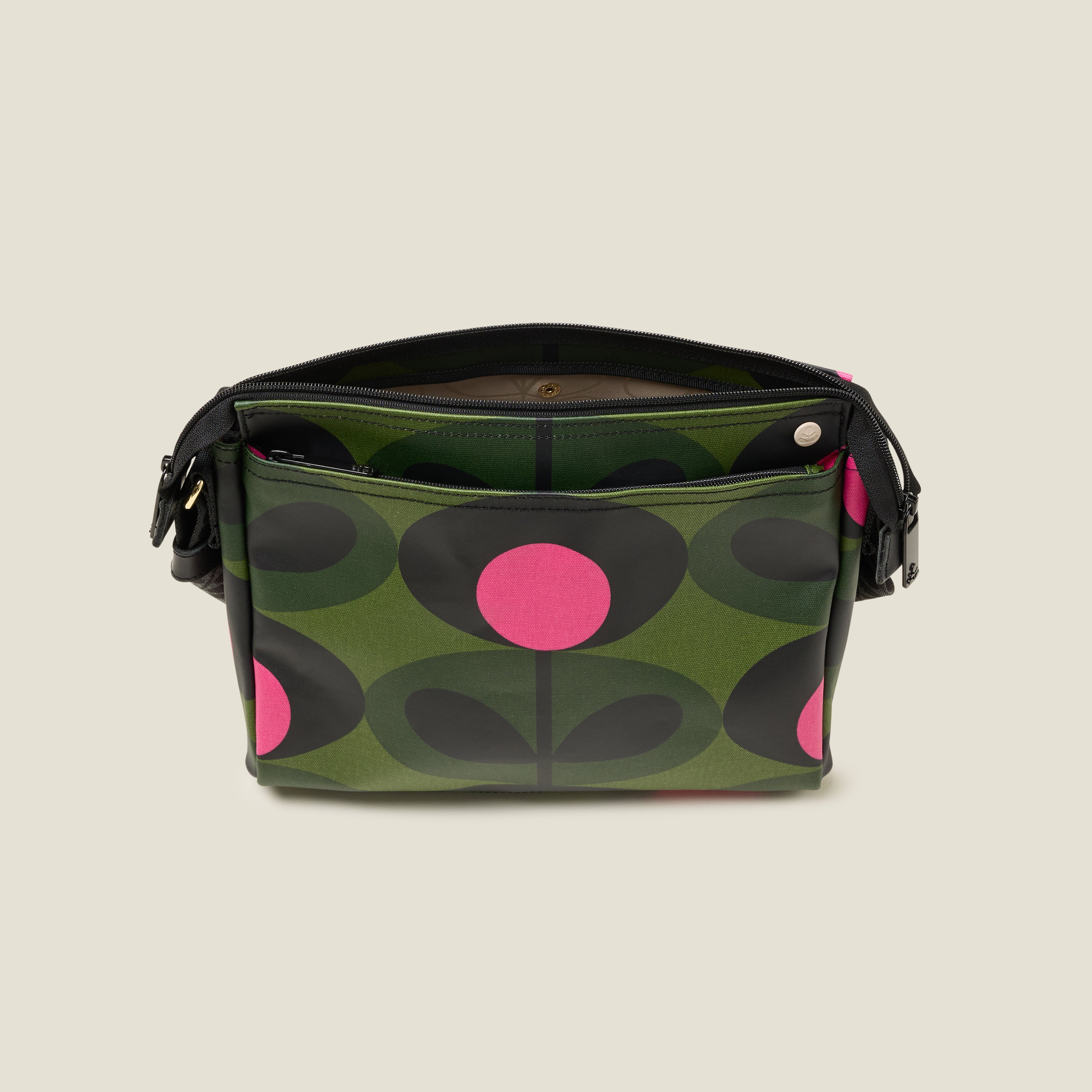 The forest green Fielder Crossbody bag top view with slip pocket and zip closure. 