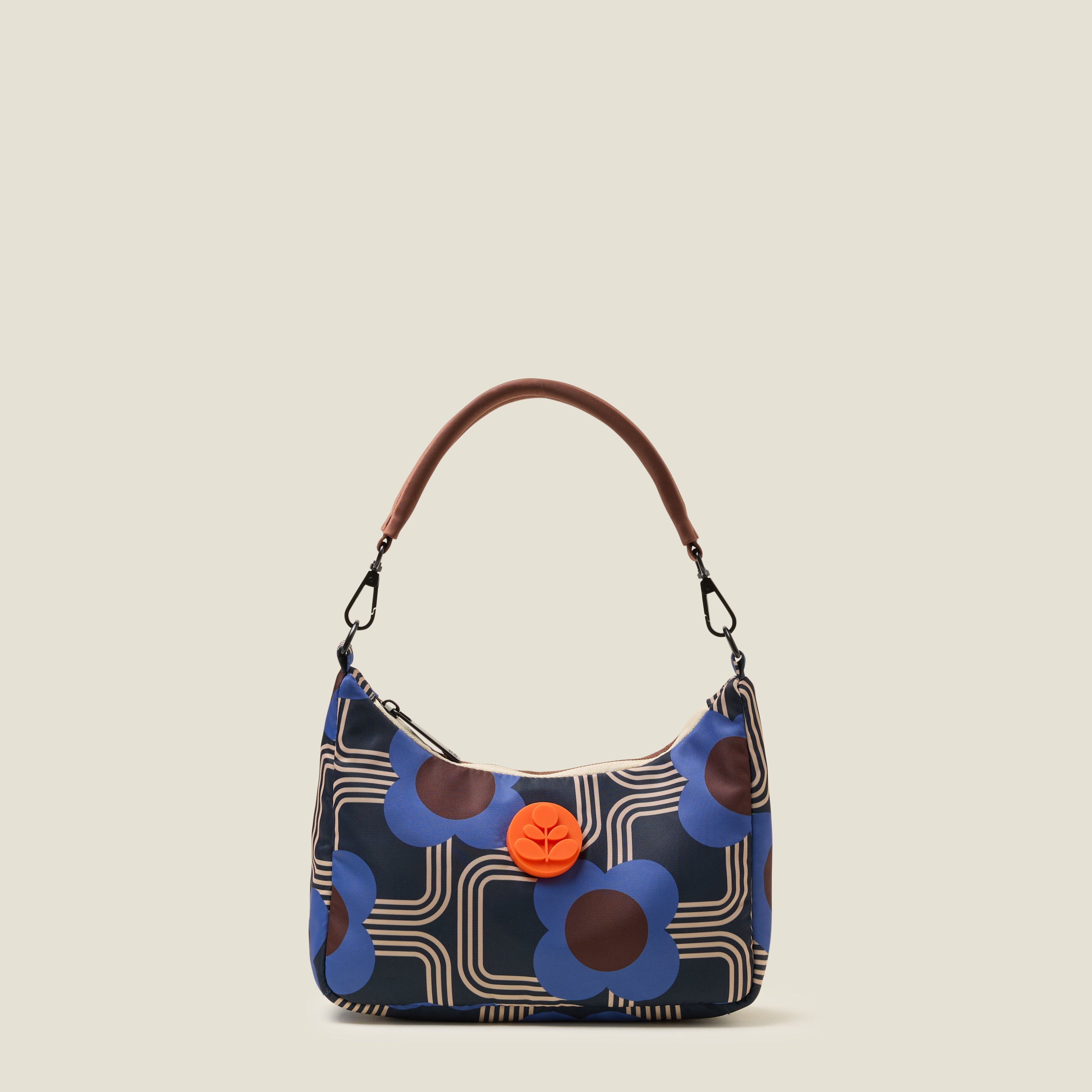 Venn handbag front view with shoulder strap with floral pattern and orange rubber flower detail.