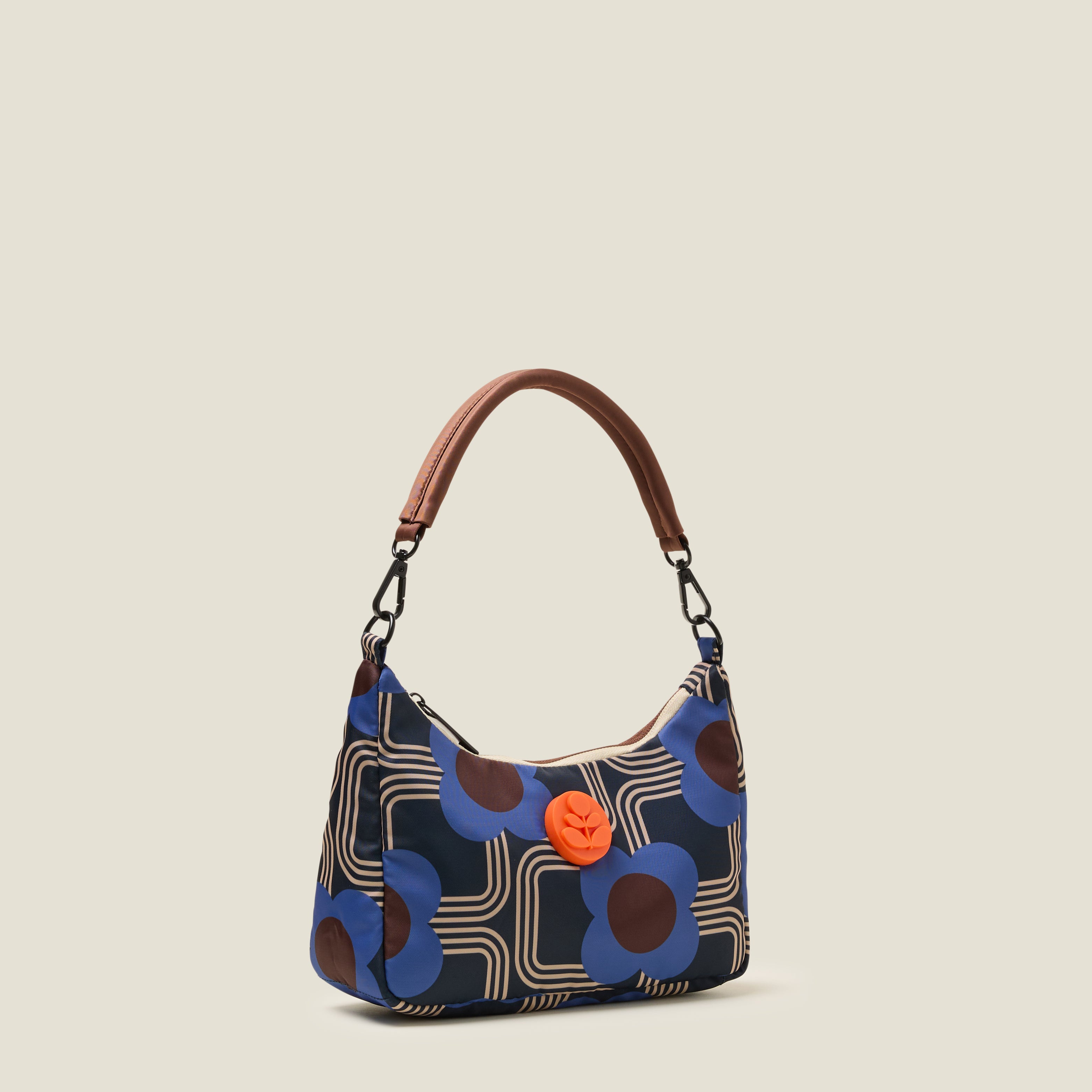 Side view of the Venn handbag with shoulder strap, featuring electric cobalt blue floral pattern with Orla Kiely rubber orange stem branding.