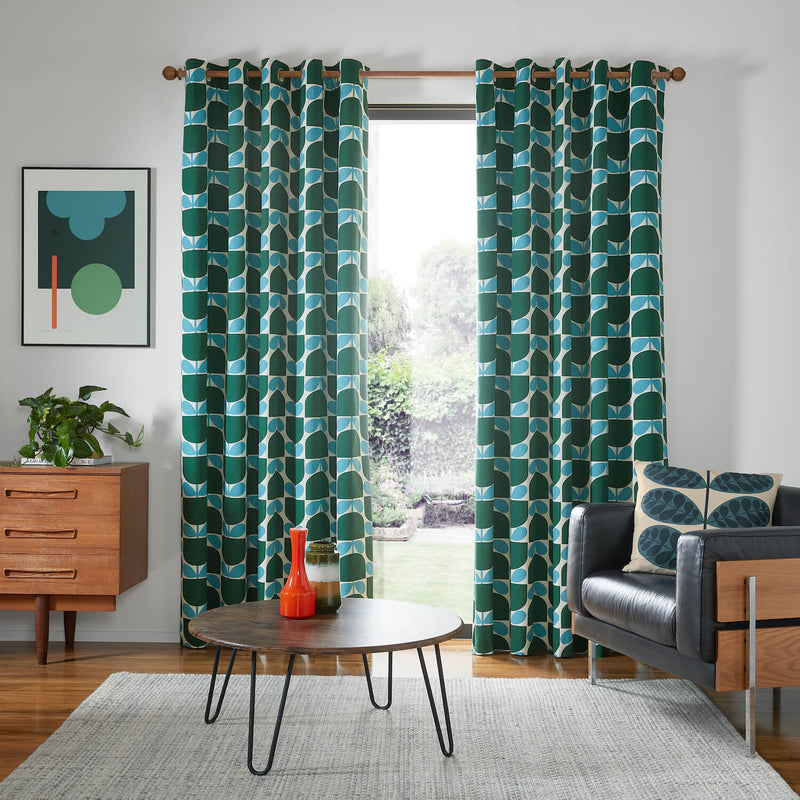 Lifestyle image of Orla Kiely's Block Stem Jade curtains in living room