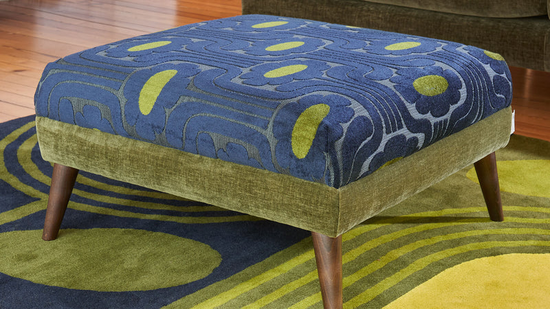 Lifestyle Image of patterned green Orla Kiely Footstool
