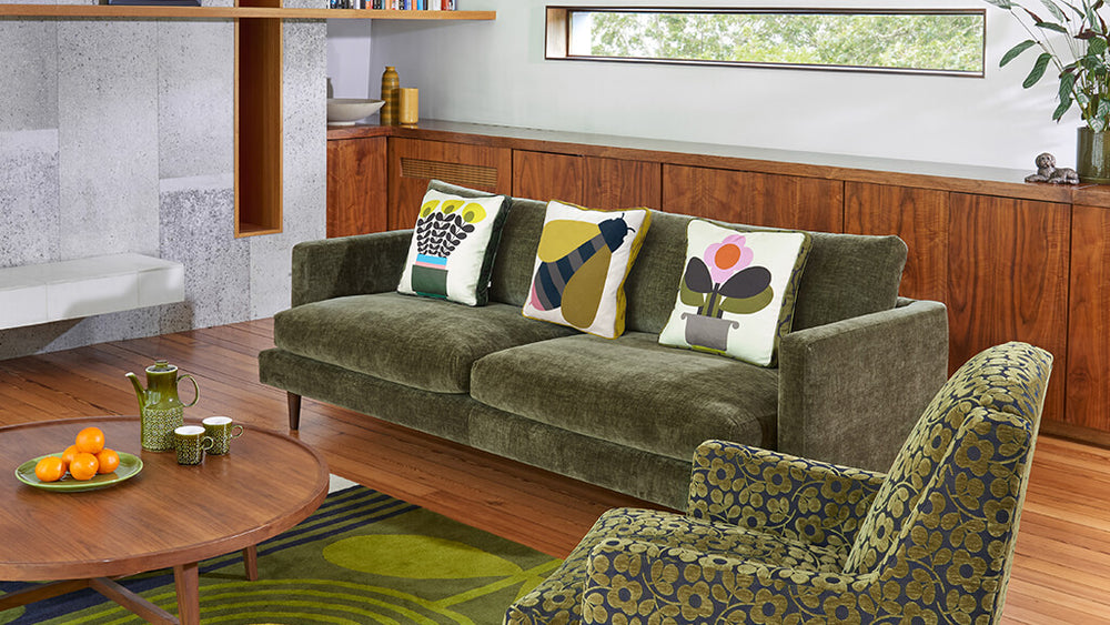 Lifestyle image of the Orla Kiely Larch Sofa in green velvet