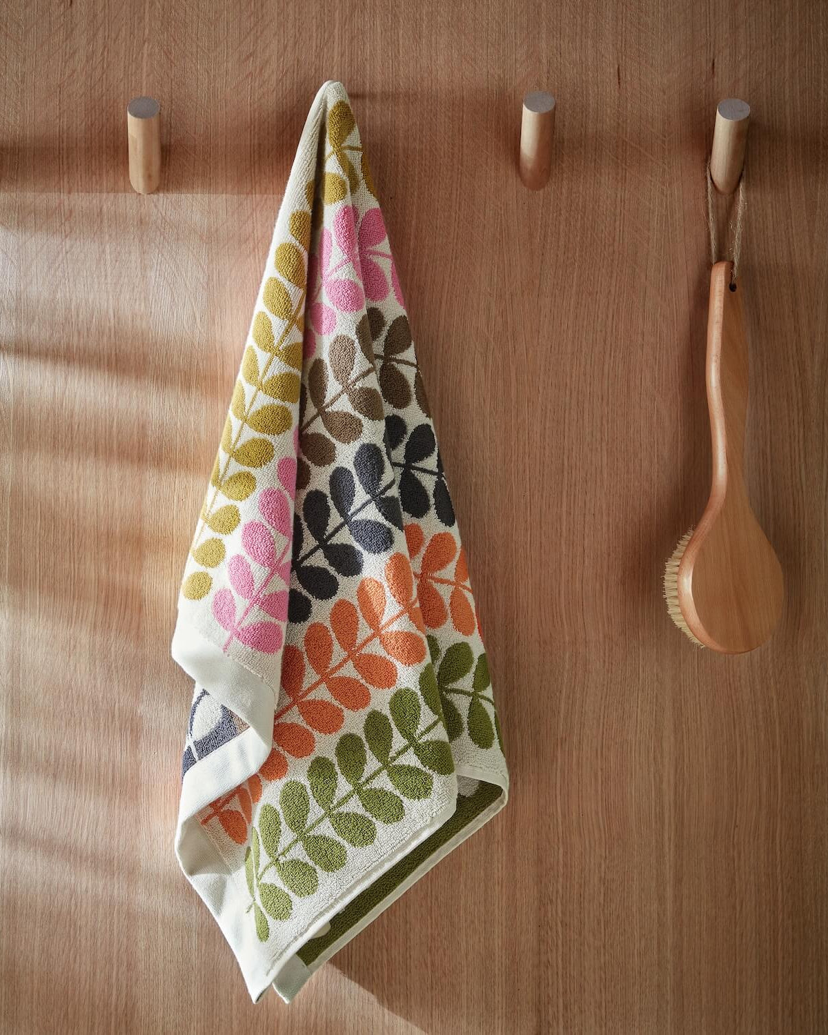 Lifestyle shot of Orla Kiely multi stem towel hanging up