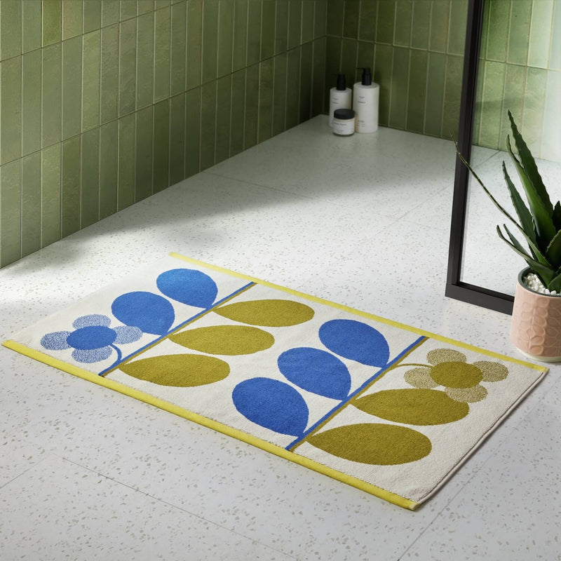 Lifestyle shot of Orla Kiely stem bloom bathmat in blue and fawn colour way