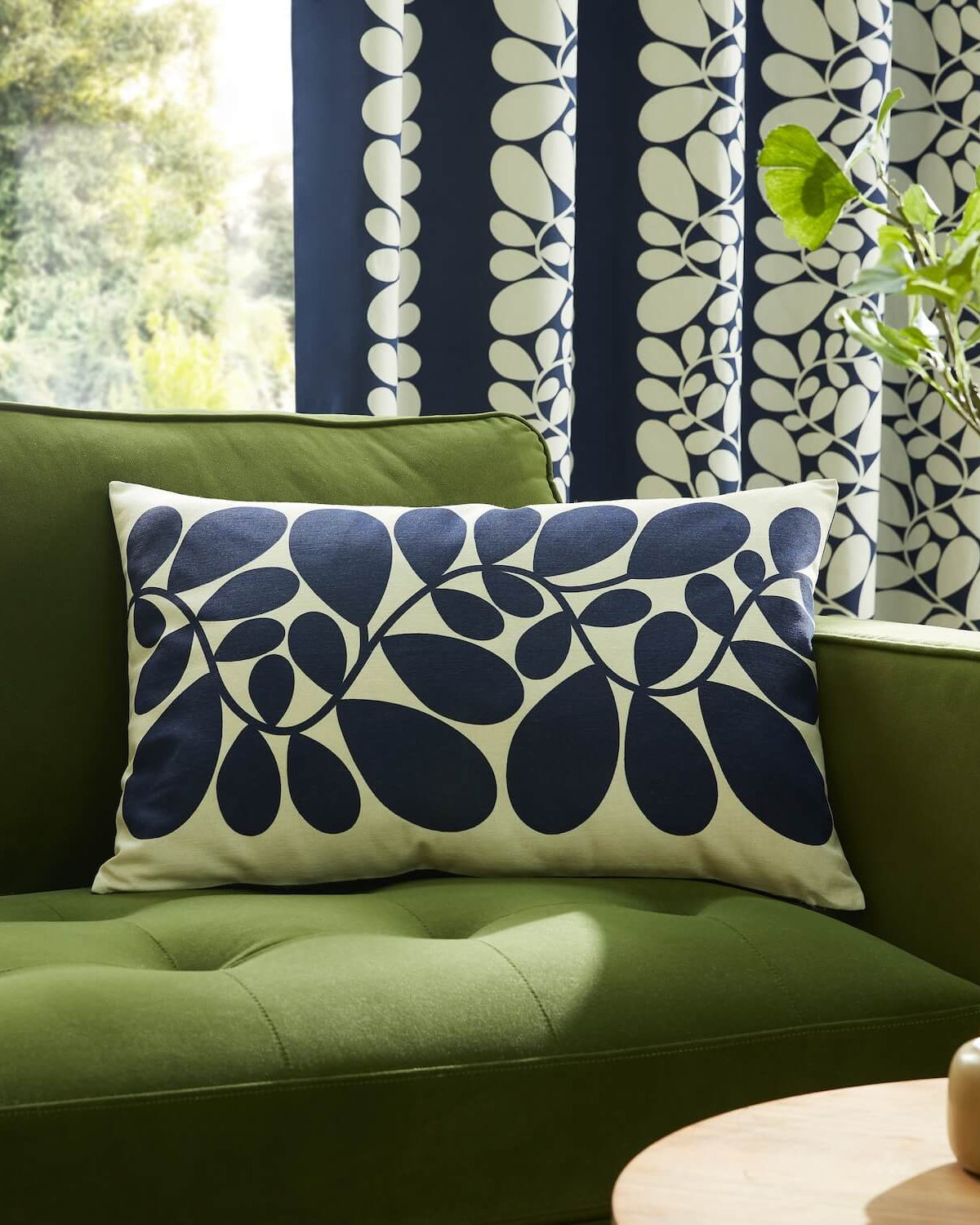 Orla Kiely sycamore stem blue and olive cushion on couch