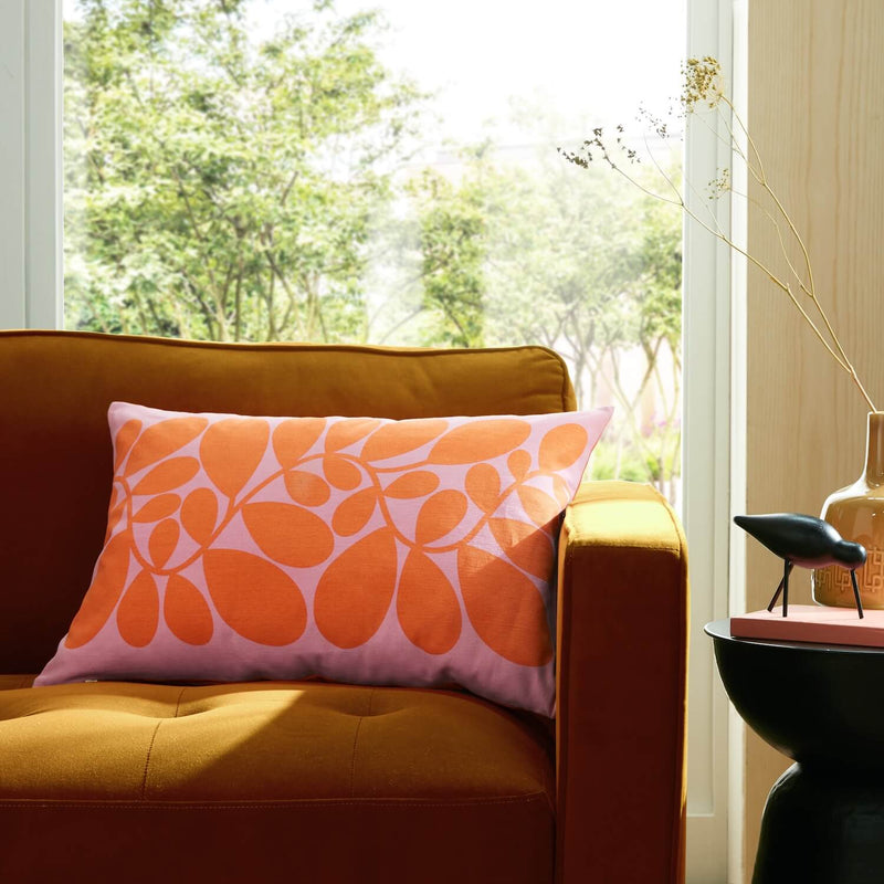 Orla Kiely sycamore stem cushion in pink on a sofa