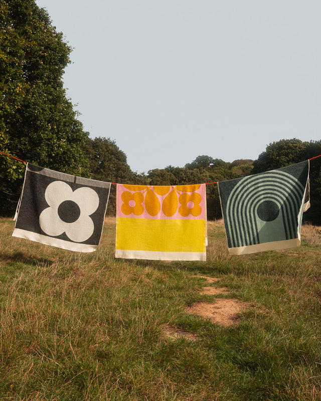 Orla Kiely blankets on a clothes line in a park